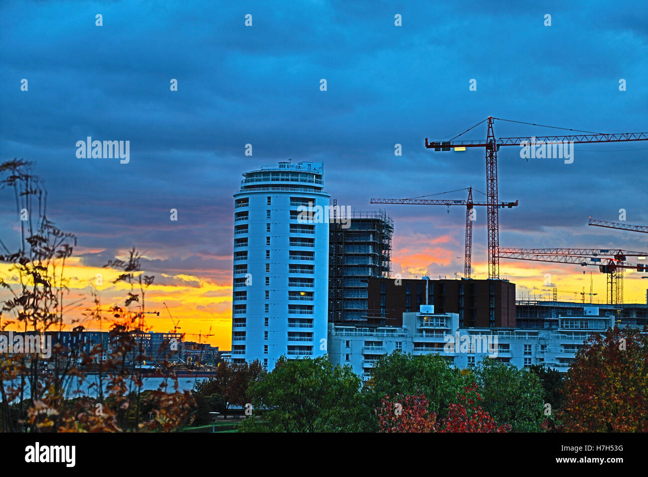 Thames Barrier Park, Silvertown, London, UK. 5th Nov, 2016. UK Weather: Colourful Autumn sunset over Thames Barrier Park in London Docklands. Extensive Building work in Royal Wharf development continues with multiple cranes Credit:  WansfordPhoto/Alamy Live News Stock Photo