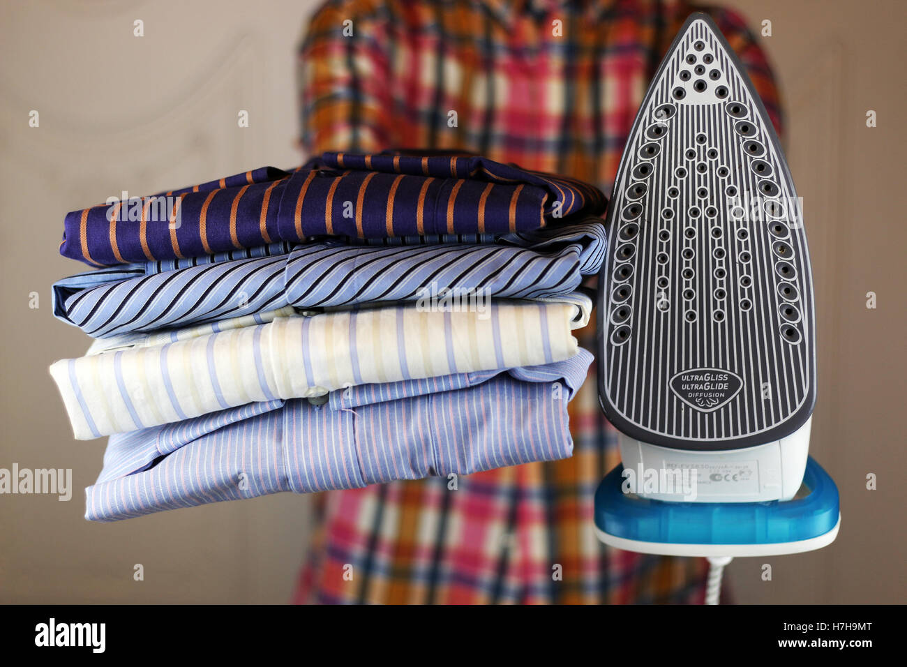 pile of ironing shirts and hand Stock Photo Alamy