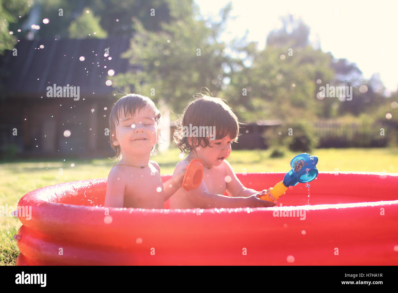 child splashing in the bath outdoors Stock Photo Alamy