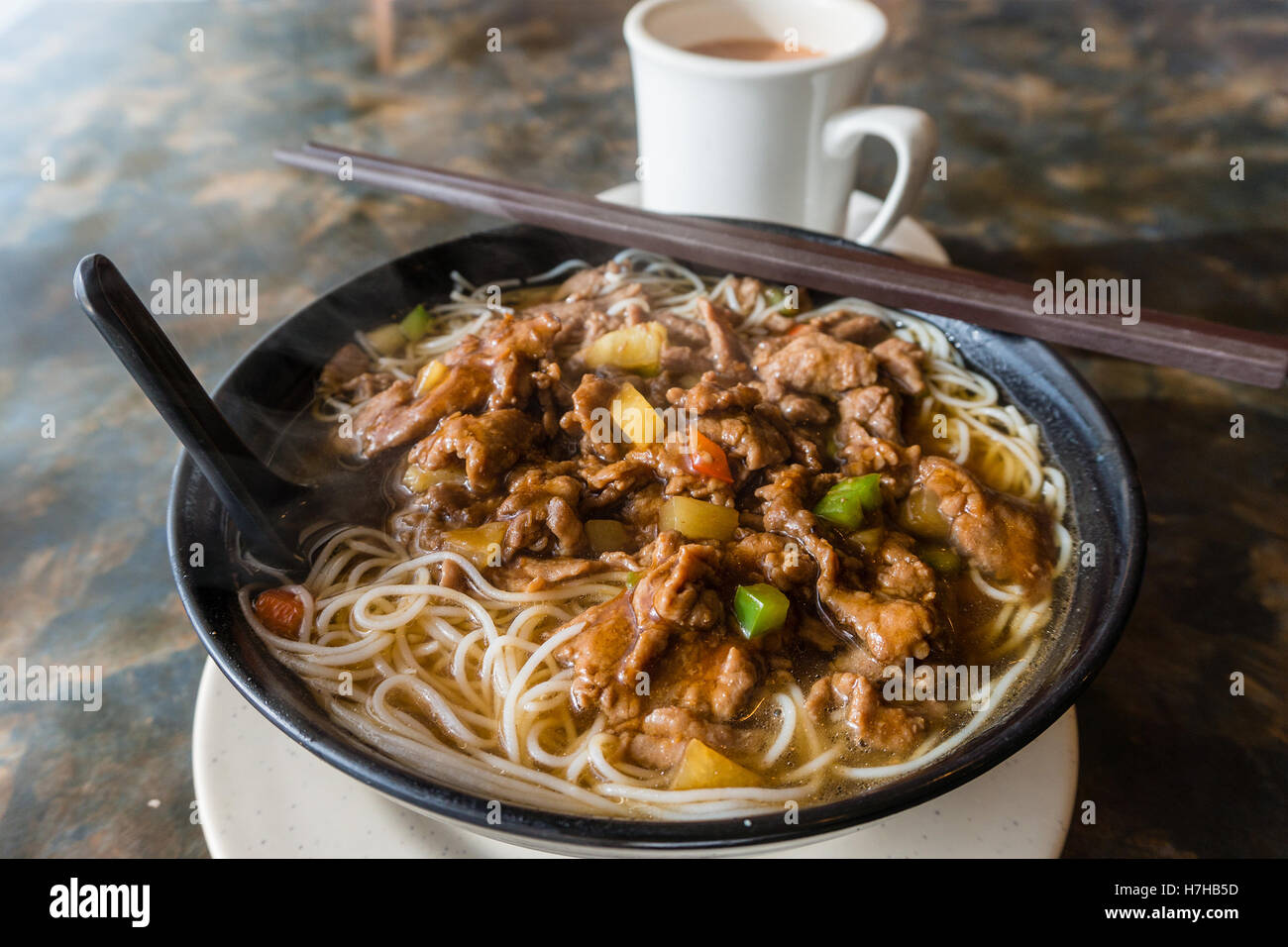 Satay beef soup noodles is featured in many Hong Kong cafes. Typically served with milk tea, a local favorite breakfast. Stock Photo