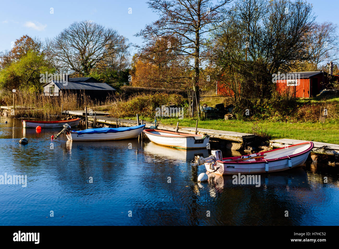 Vieryd, Sweden - October 29, 2016: Environmental documentary of coastal lifestyle. Small marina with moored boats and cabins in Stock Photo