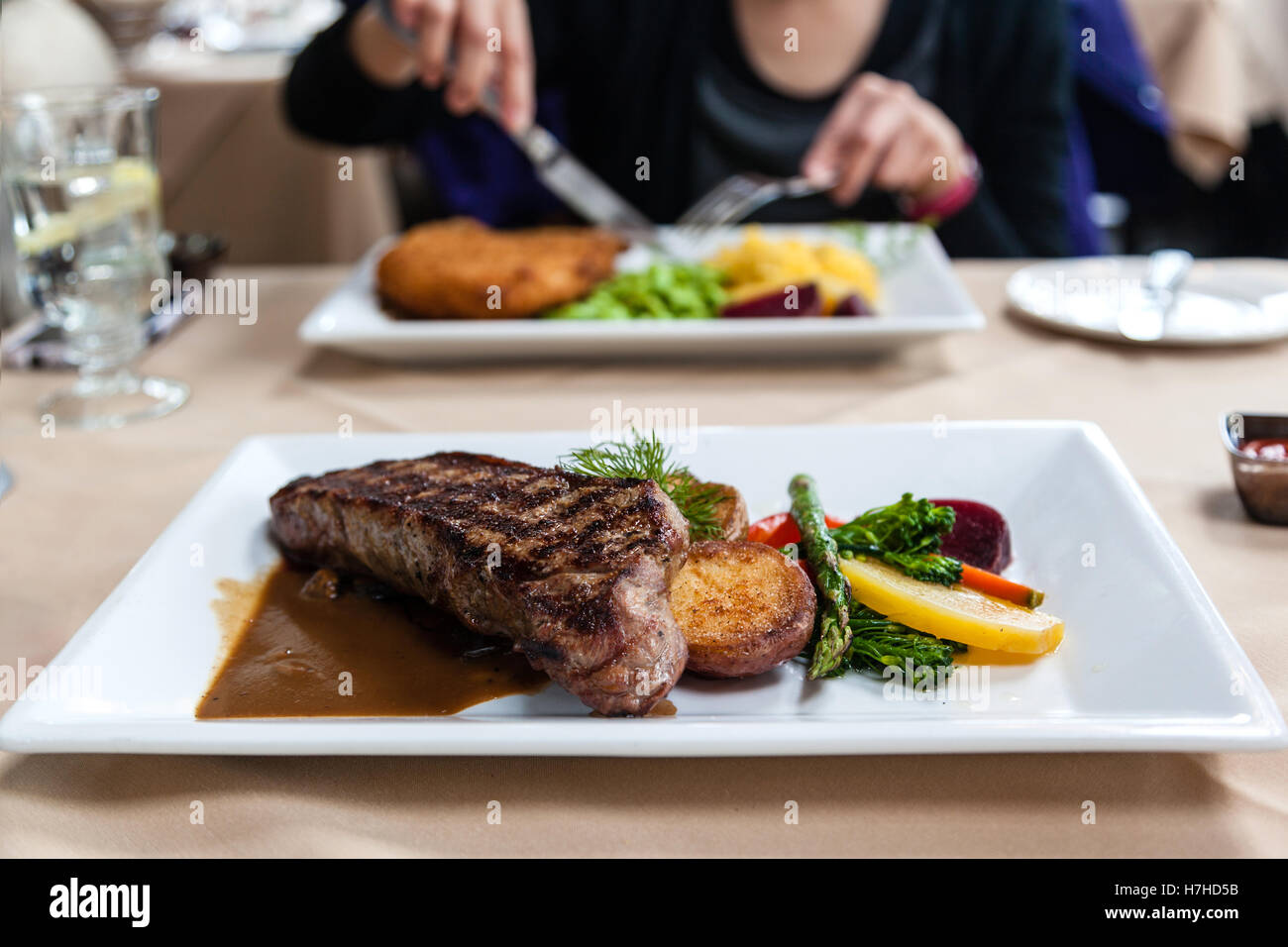 A delicious strip loin beef steak meal served with fresh vegetables and