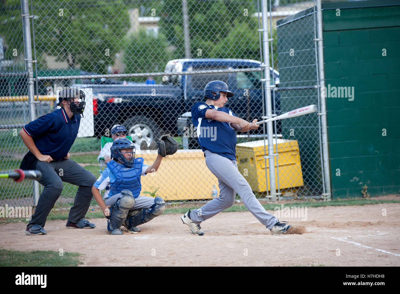 Little league teenage slugger swinging at baseball. St Paul Minnesota MN USA Stock Photo