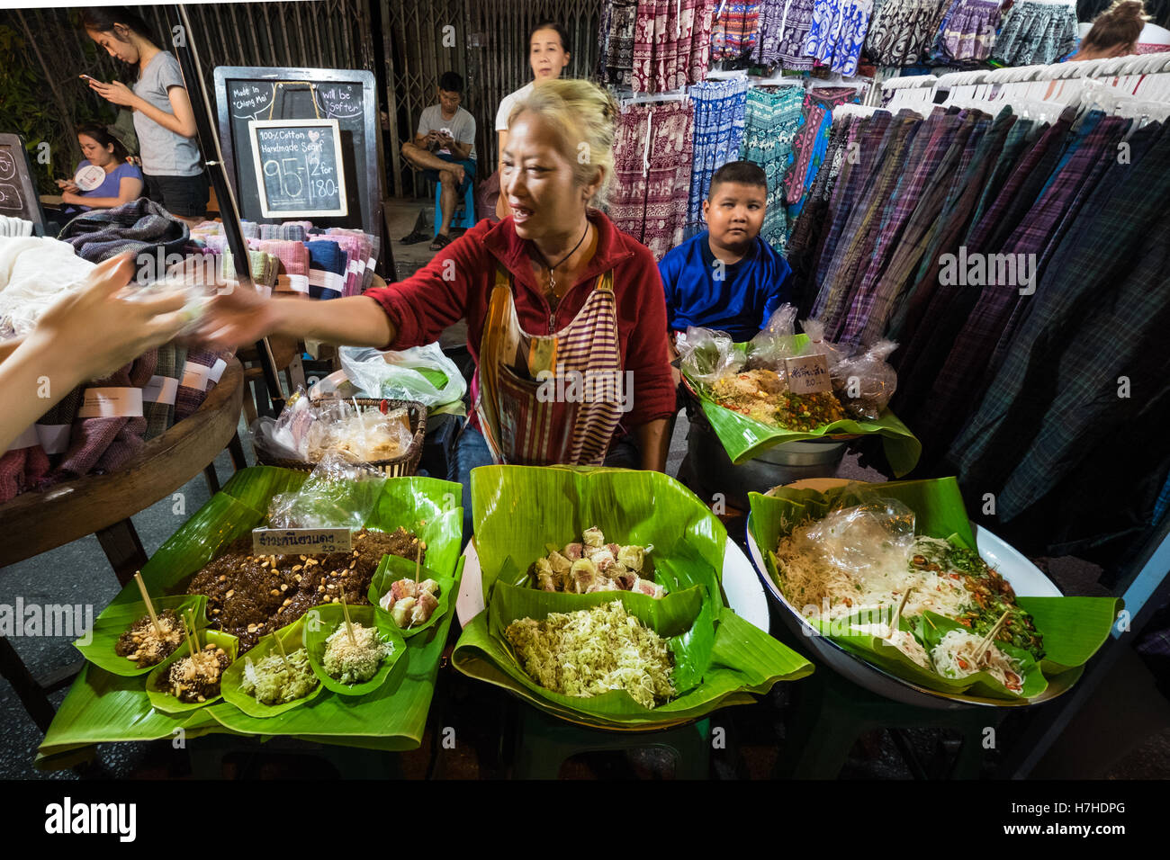 A woman selling food at Chiang Mai Walking Night Market, Thailand Stock ...