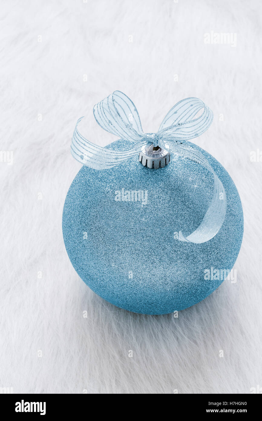 One beautiful, fancy,  perfect, sparkly, shiny, blue glitter Christmas ornament on vertical white background Stock Photo
