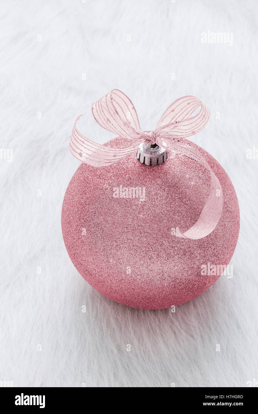 One beautiful, fancy,  perfect, sparkly, shiny, pink glitter Christmas ornament on vertical white background Stock Photo