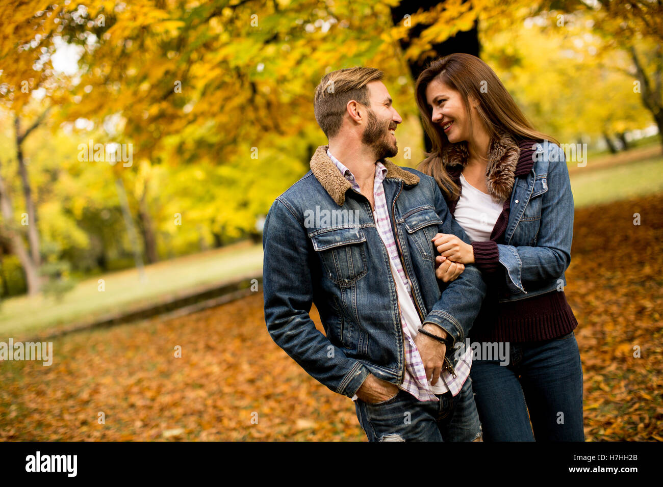 Young loving couple having a walk in the autumn park Stock Photo - Alamy