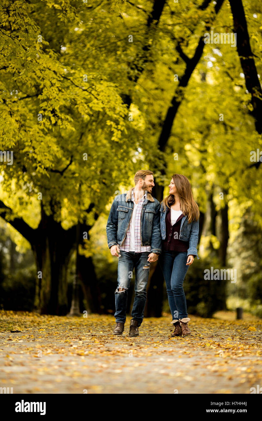 Young loving couple having a walk in the autumn park Stock Photo - Alamy