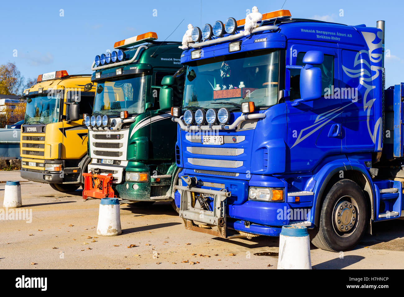Brakne Hoby, Sweden - October 29, 2016: Documentary of industrial area. Three parked Scania trucks seen from the front. Stock Photo