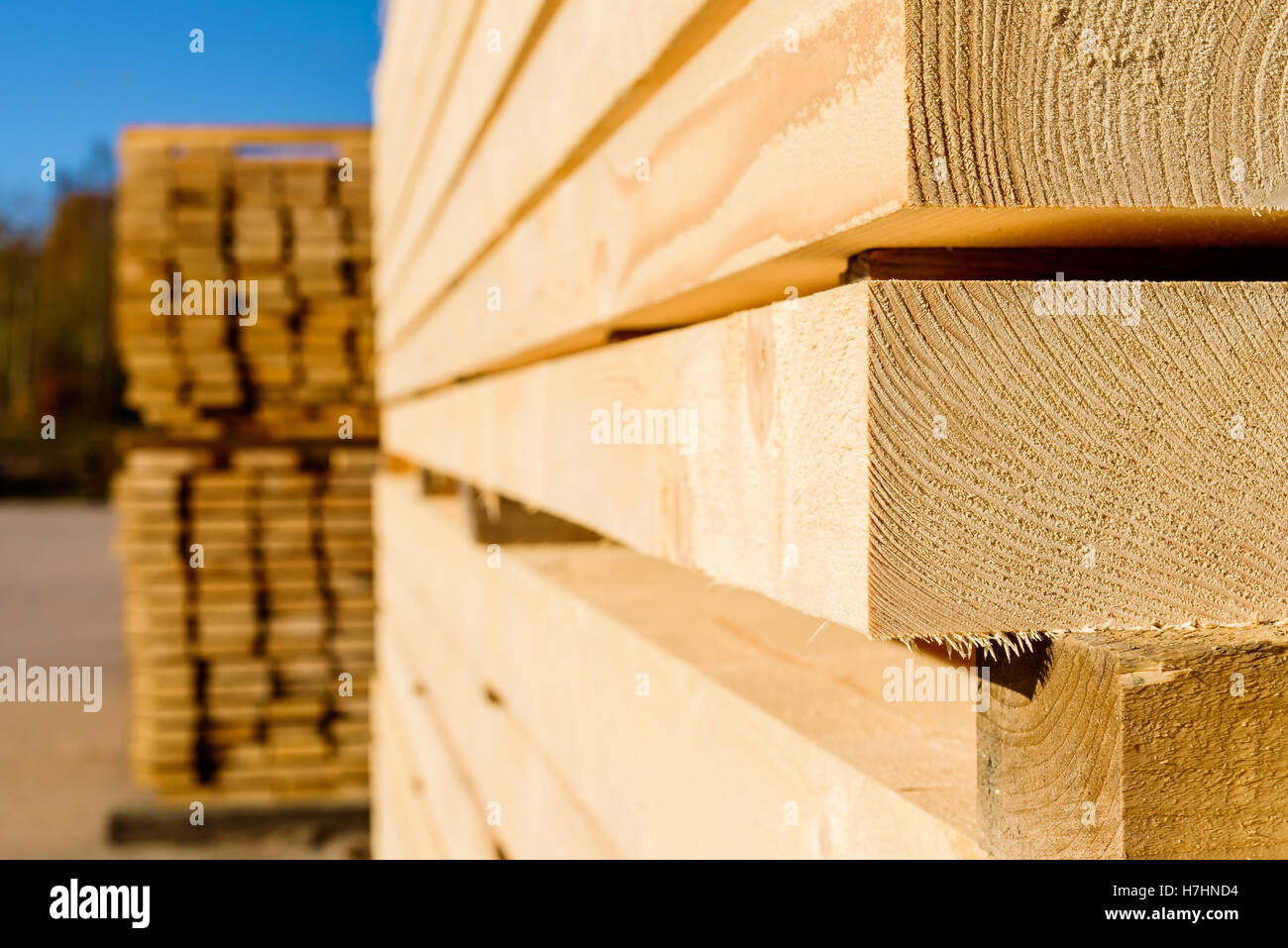 Corner parts of stacked lumber or timber. Stock Photo
