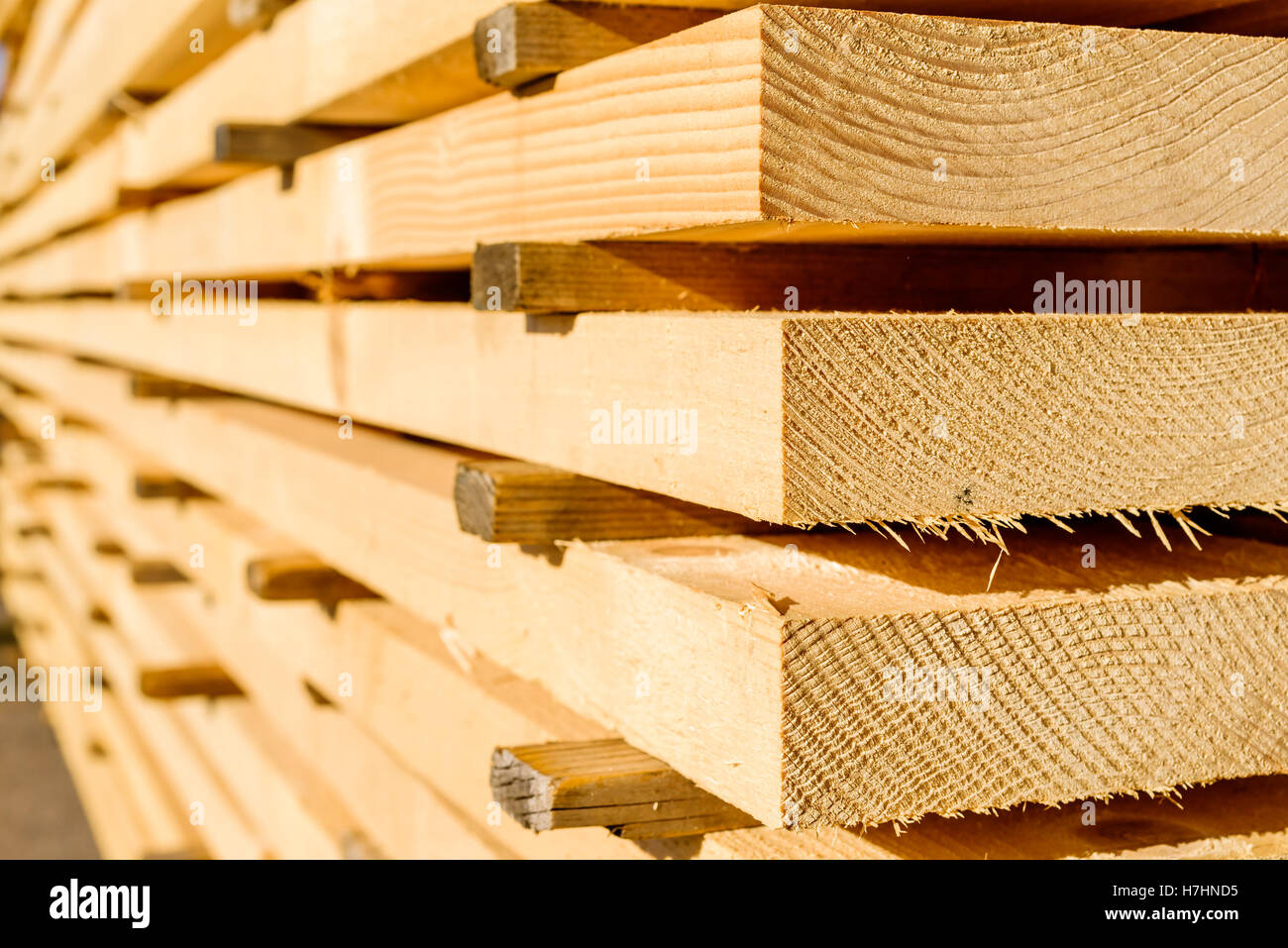 Corner parts of stacked lumber or timber. Stock Photo