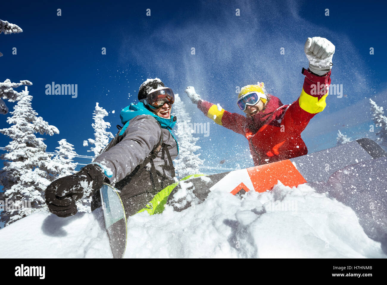 Happy couple of snowboarders having fun Stock Photo
