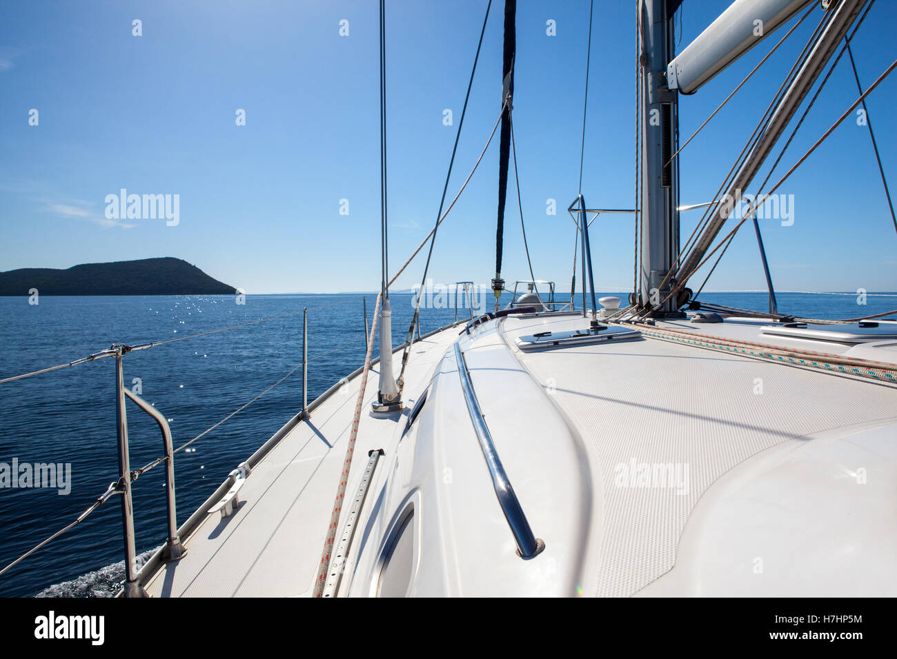 The white sails of yachts on the background sea and sky in the clouds