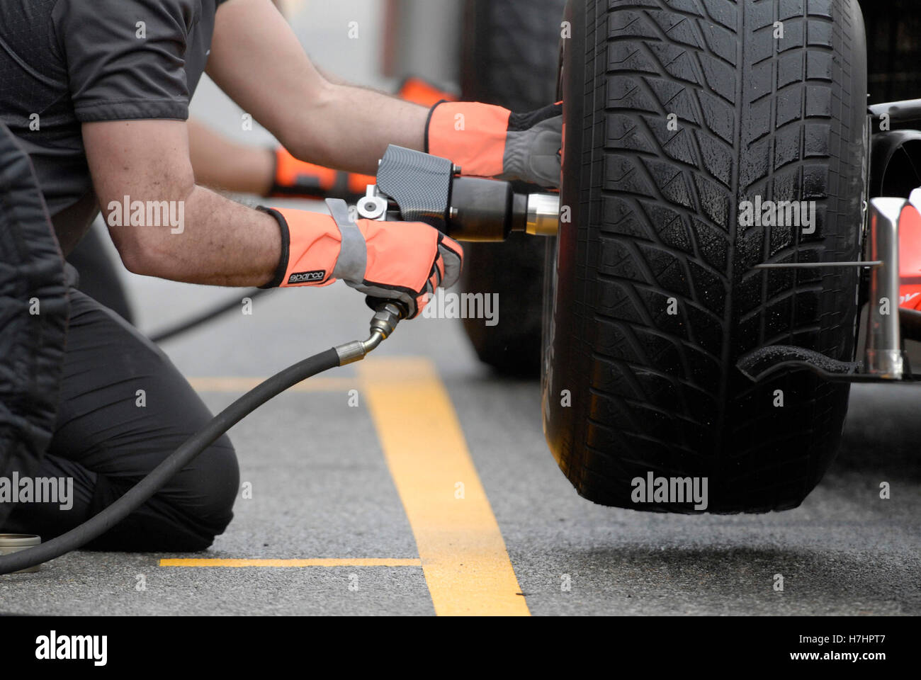 Changing tyres on a Formula 1 racing car at the Circuit de Catalunya
