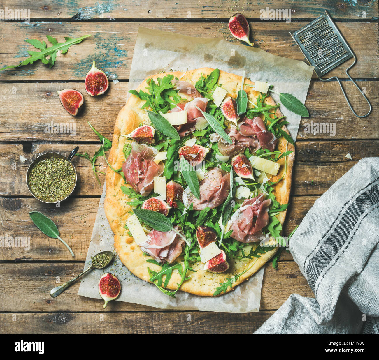 Fig, prosciutto, arugula, sage flatbread pizza with spices in mug Stock