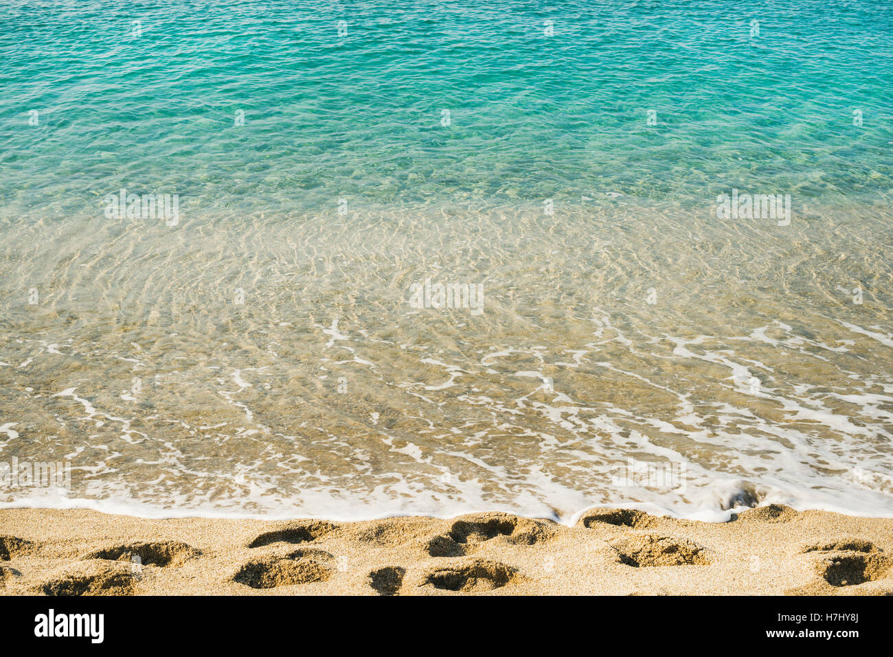 Clear water and footprints at Cleopatra beach, Alanya, Turkey Stock Photo