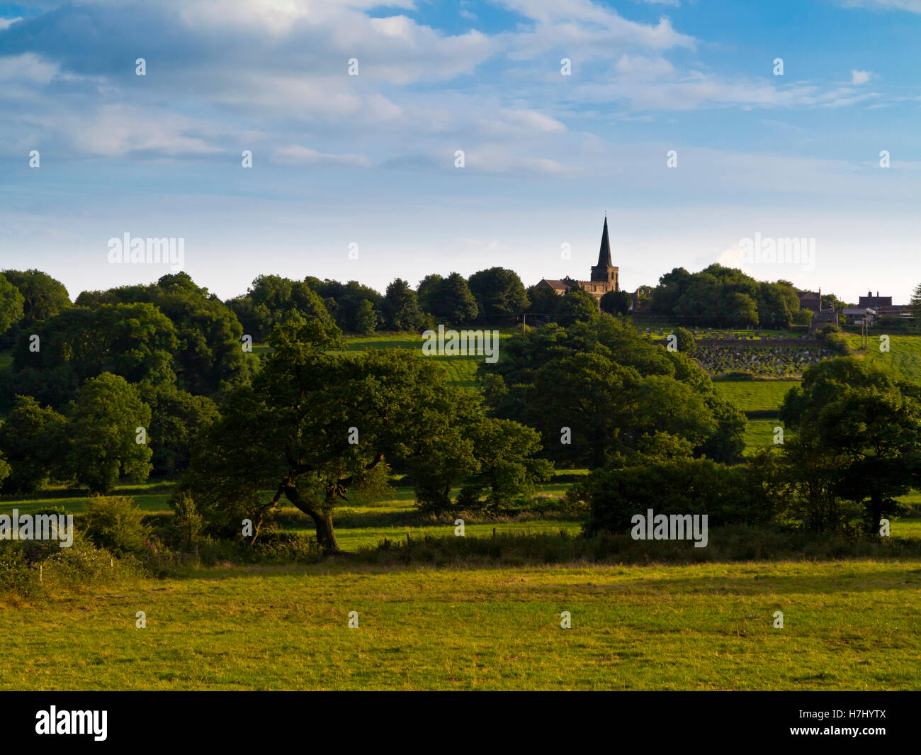 View across the Peak District countryside towards the spire of Crich village church in summer Derbyshire England UK Stock Photo