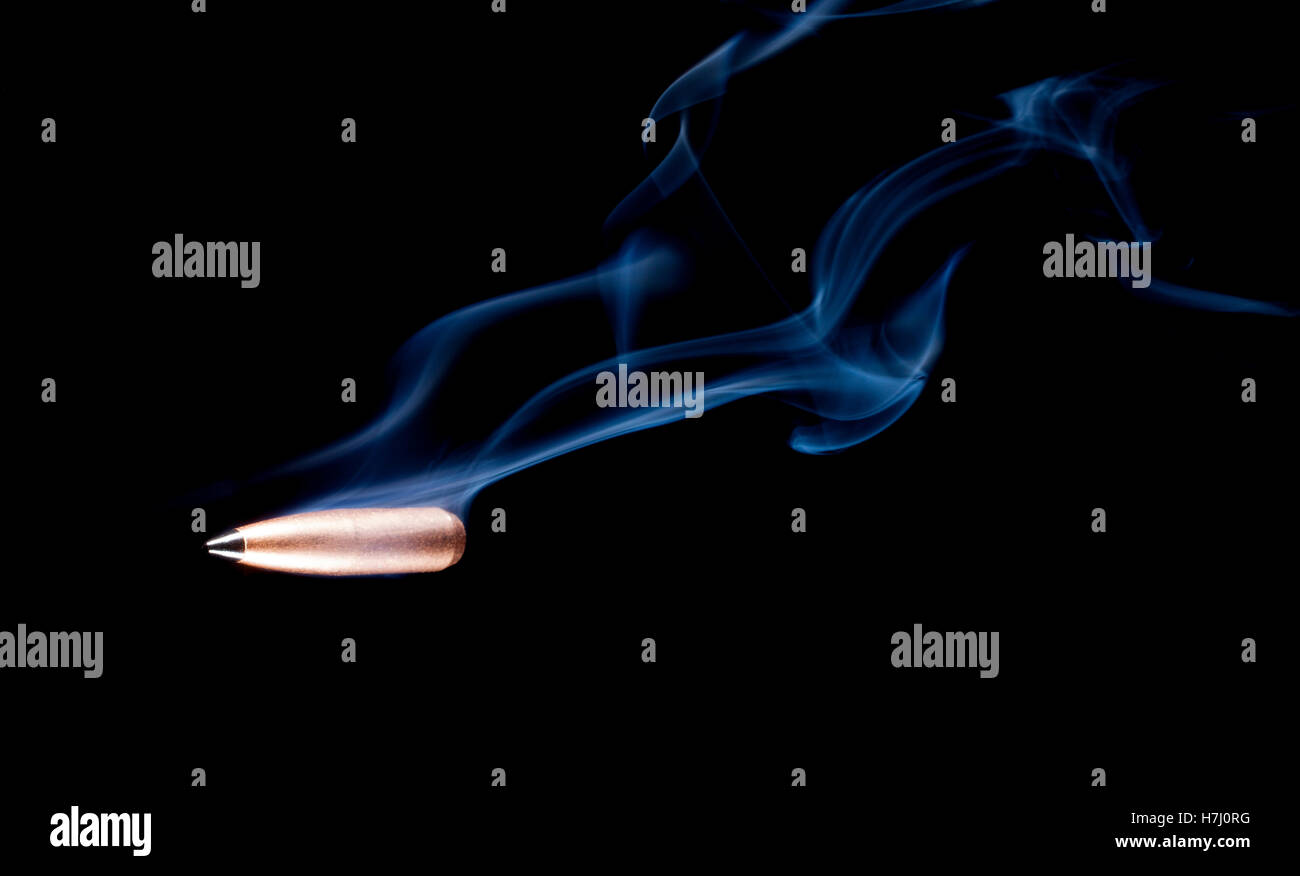 Copper jacketed lead bullet with a polymer tip and smoke behind Stock