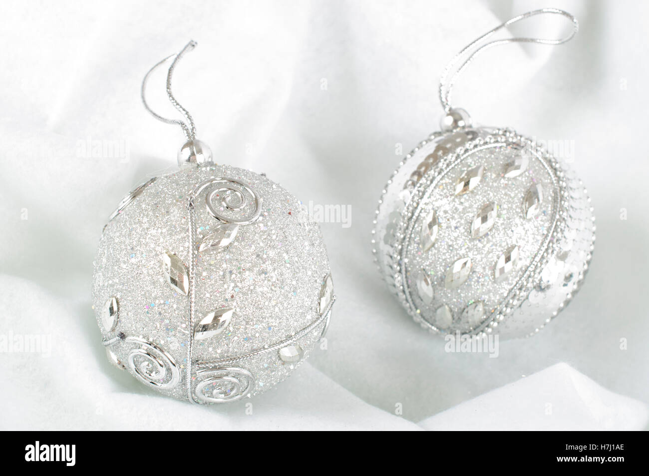 Christmas Baubles on snow white background Stock Photo