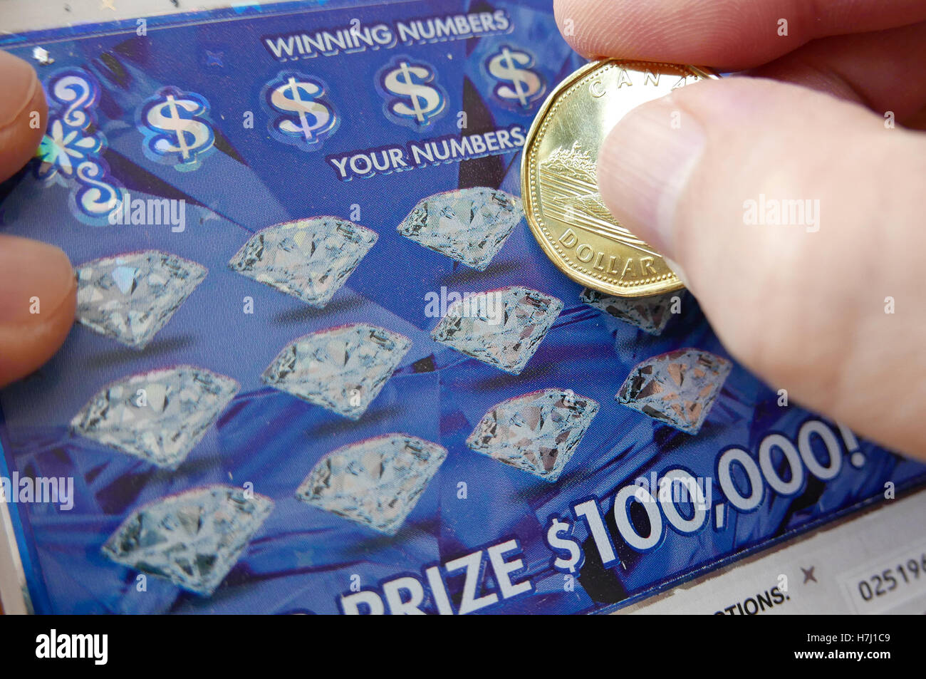 Coquitlam BC Canada - June 04, 2015 : Woman scratching lottery ticket The British Columbia Lottery Corporation has provided gove Stock Photo