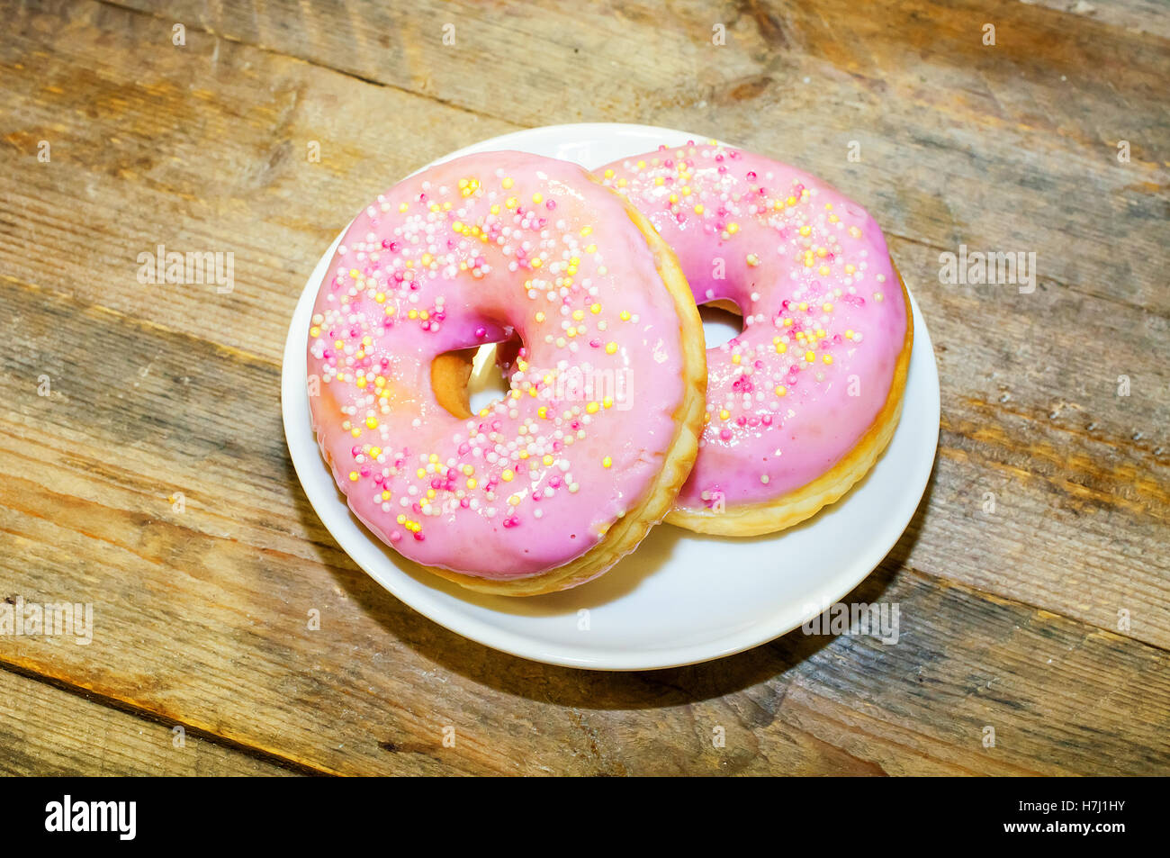 Two sweet donut with pink frosting Stock Photo