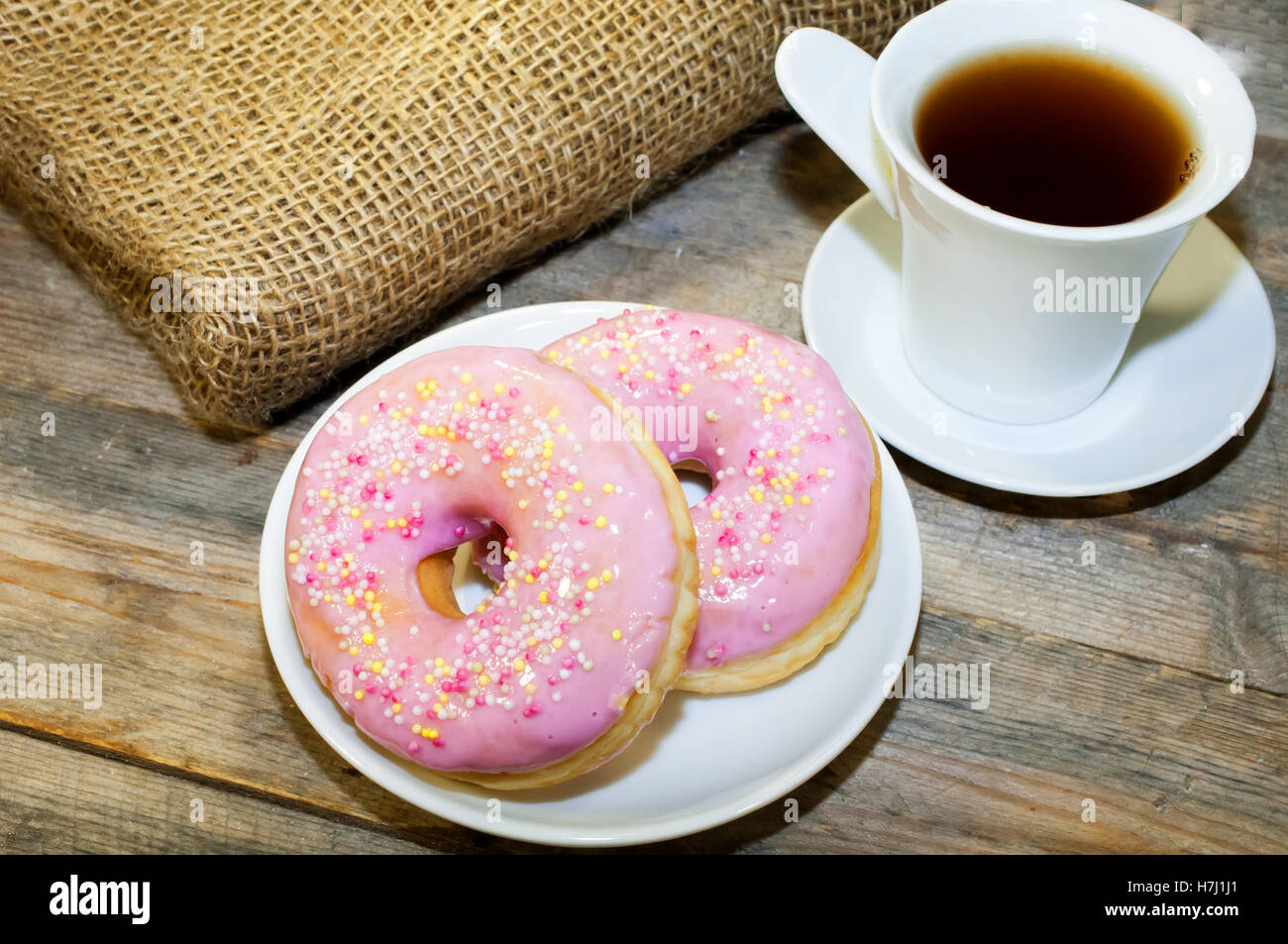 Sweet donut with pink frosting and sprinkles Stock Photo