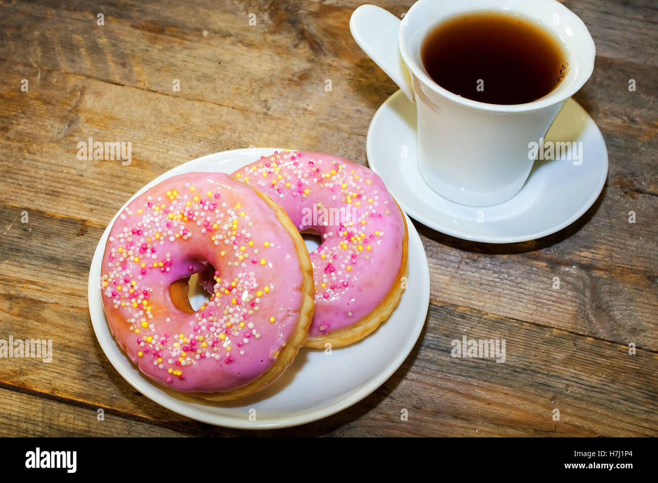 Sweet donut with pink frosting and sprinkles Stock Photo