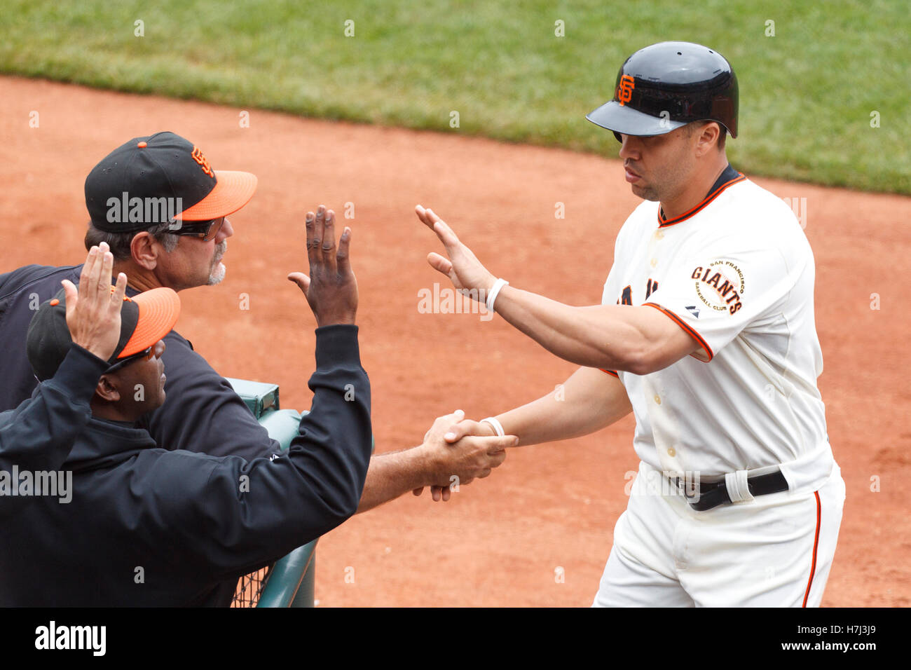 August 7, 2011; San Francisco, CA, USA;  San Francisco Giants right fielder Carlos Beltran (right) is congratulated by manager Bruce Bochy (left, top) after scoring a run against the Philadelphia Phillies during the fifth inning at AT&T Park. Stock Photo