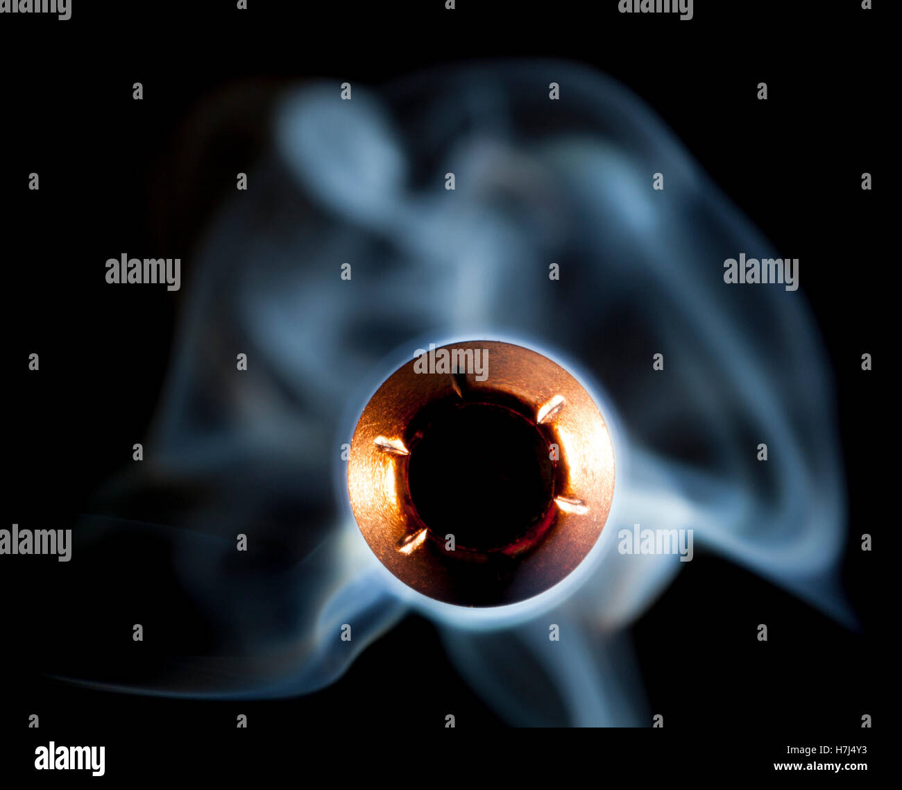 Copper jacketed hollow point and smoke coming at the camera Stock Photo