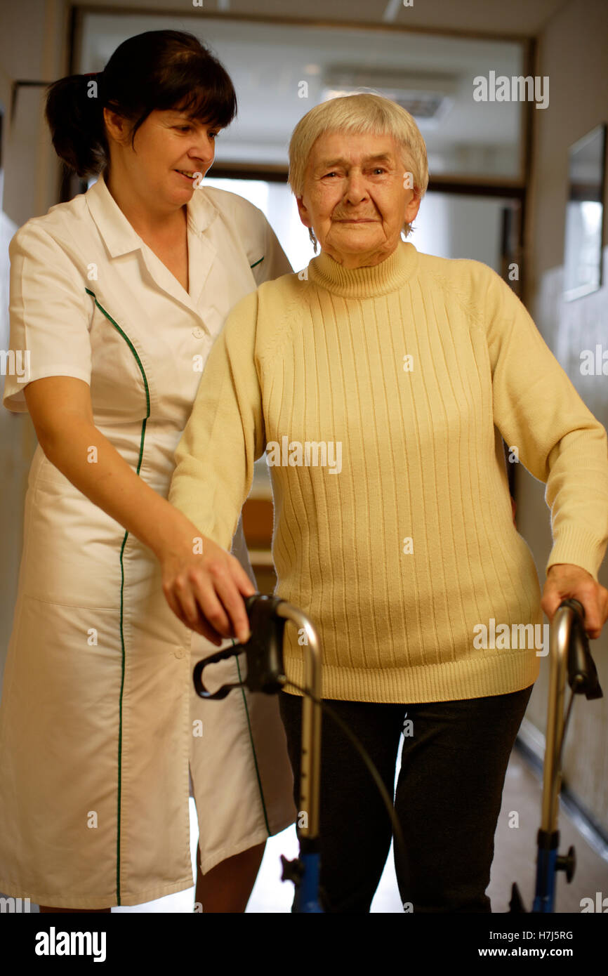 Nursing home, old woman with nurse Stock Photo