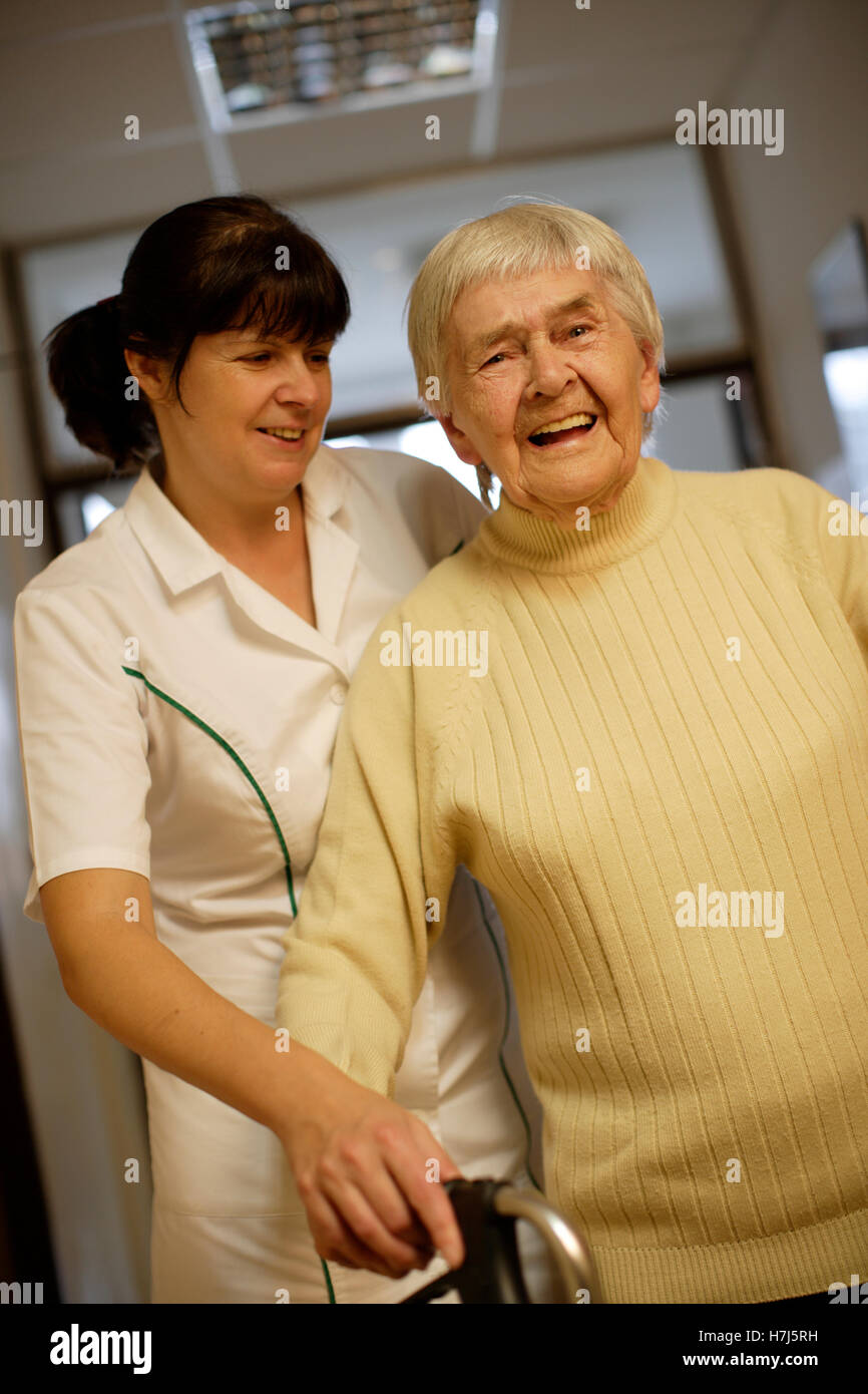 Nursing home, old woman with nurse Stock Photo