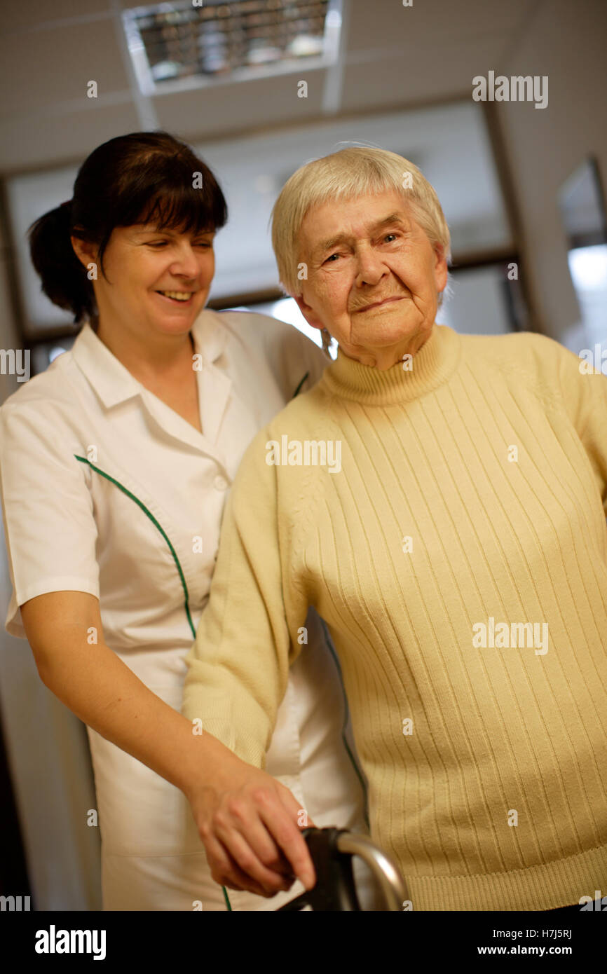 Nursing home, old woman with nurse Stock Photo