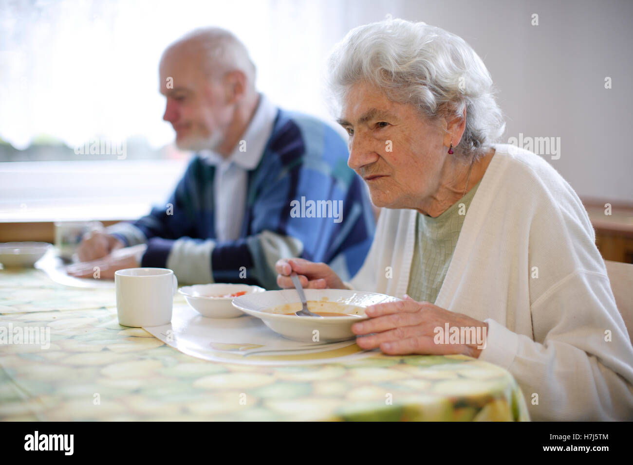 Old woman in a nursing home eating soup Stock Photo