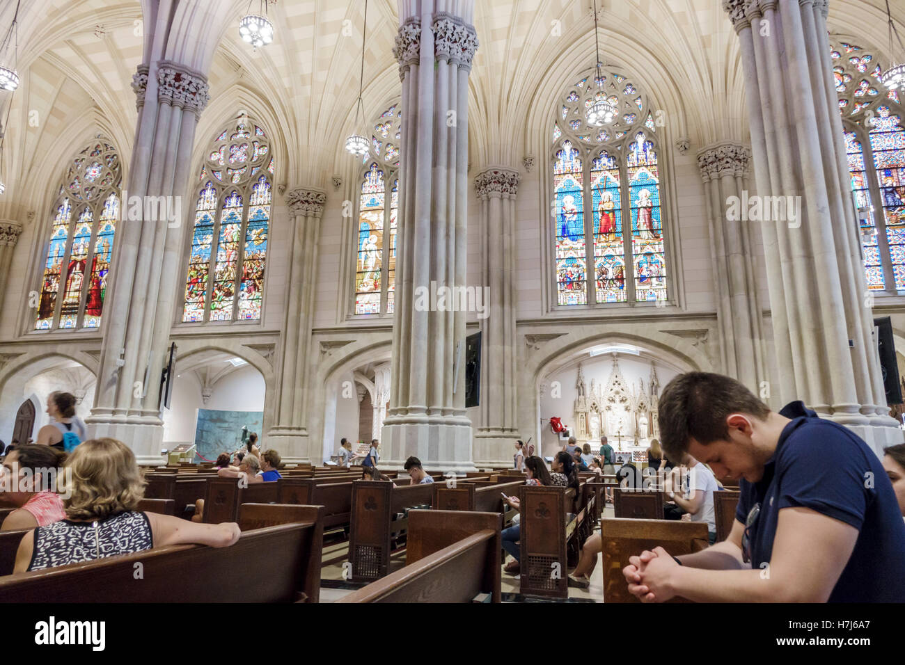 New York City,NY NYC Manhattan,Midtown,Fifth Avenue,St. Patrick's Cathedral,Catholic church,interior inside,Neo-Gothic,nave,stained glass window,pews, Stock Photo