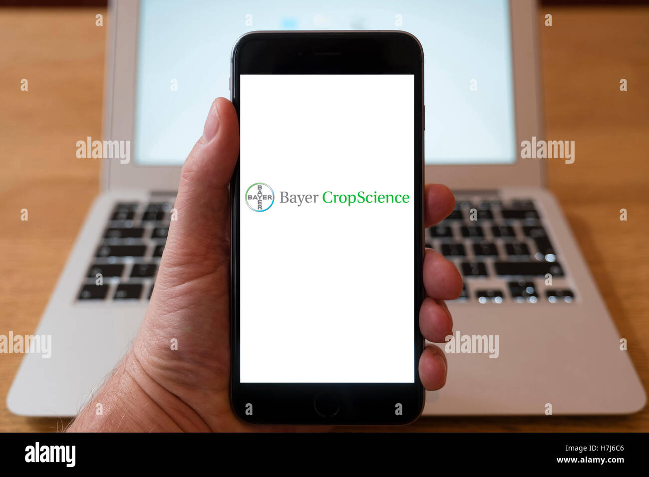 Using iPhone smart phone to display logo of Bayer CropScience a biotech company Stock Photo