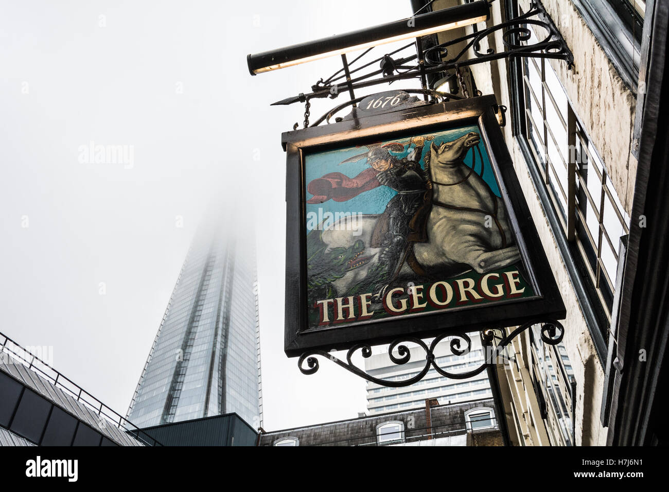 Exterior view of the George Inn pub sign and Shard skyscraper off Borough High Street, Southwark, London, England, U.K. Stock Photo