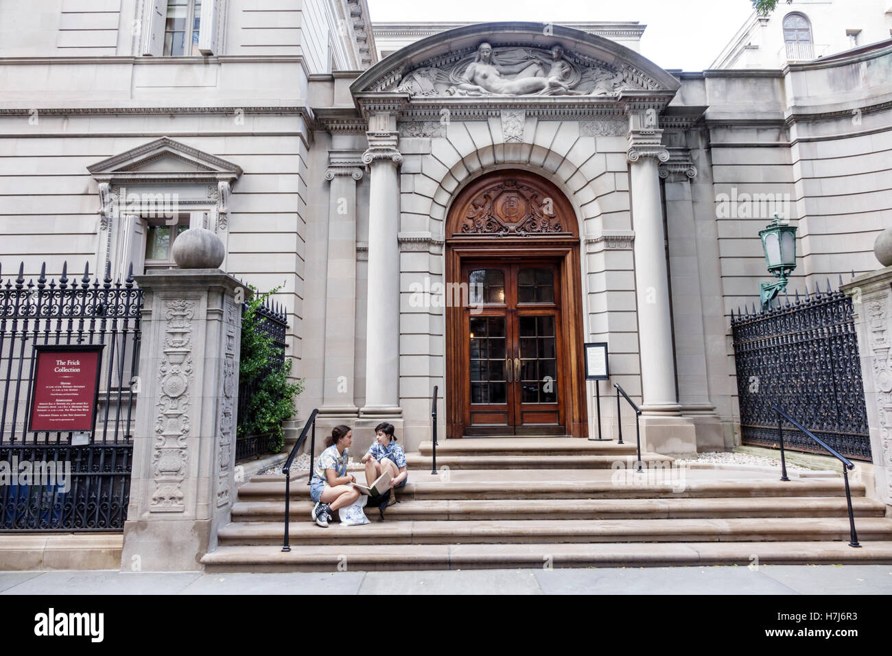 New York City,NY NYC,Manhattan,Upper East Side,The Frick Collection,art artwork museum,exterior,main entrance,arched pediment,teen teens teenage teena Stock Photo