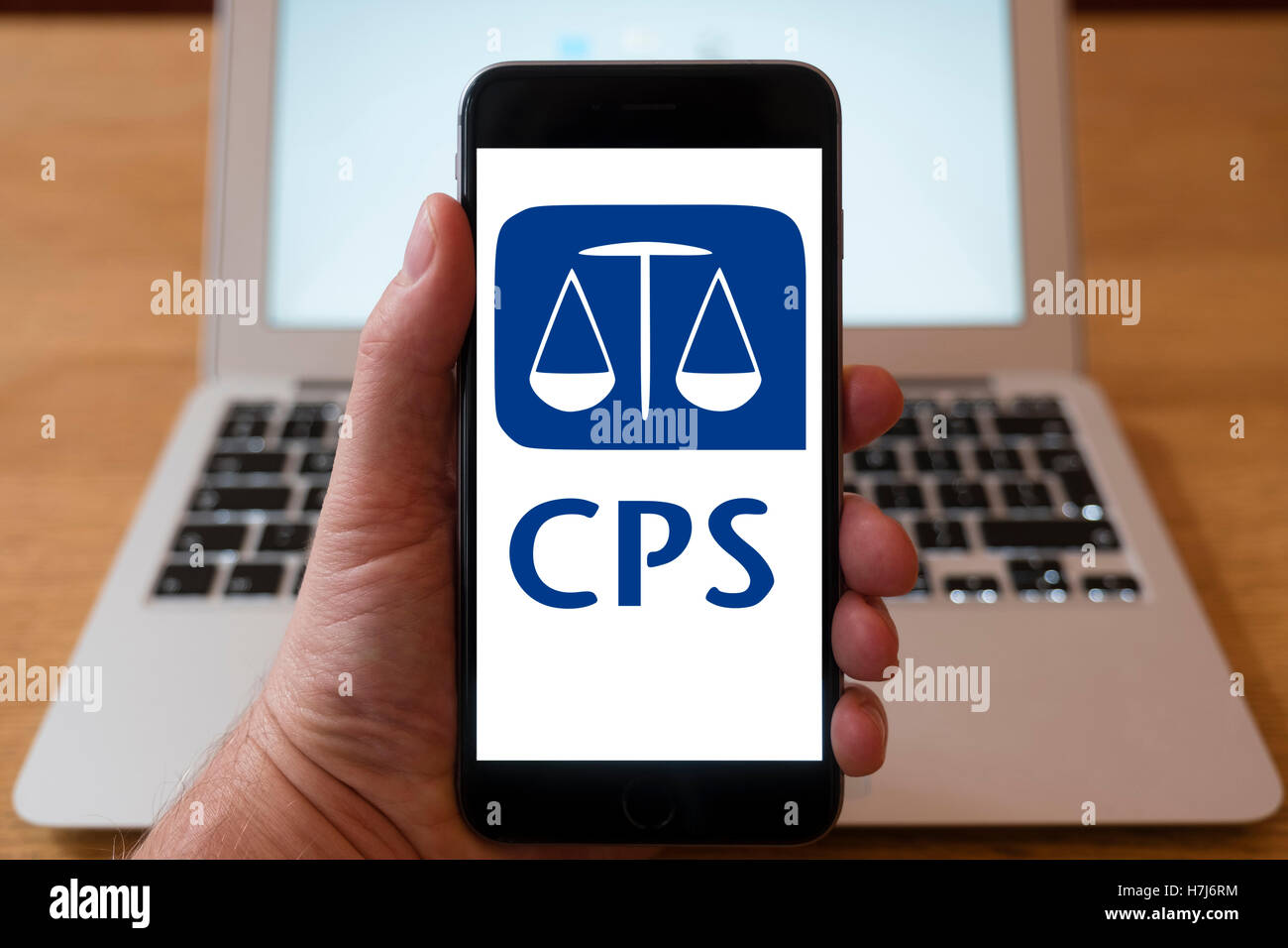 Using iPhone smart phone to display logo of Crown Prosecution Service, in the UK Stock Photo