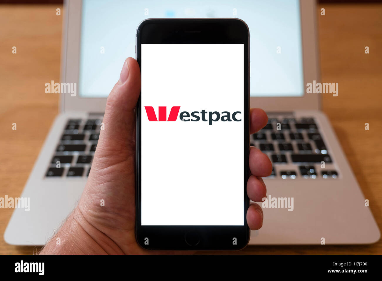 Using iPhone smartphone to display logo of Westpac, Australian bank and financial-services provider Stock Photo