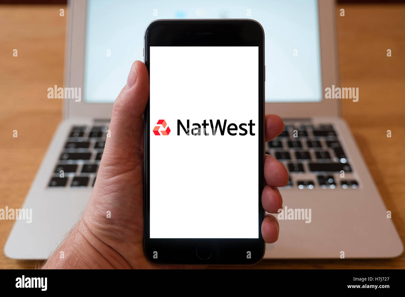 Using iPhone smartphone to display logo of NatWest Bank Stock Photo Alamy