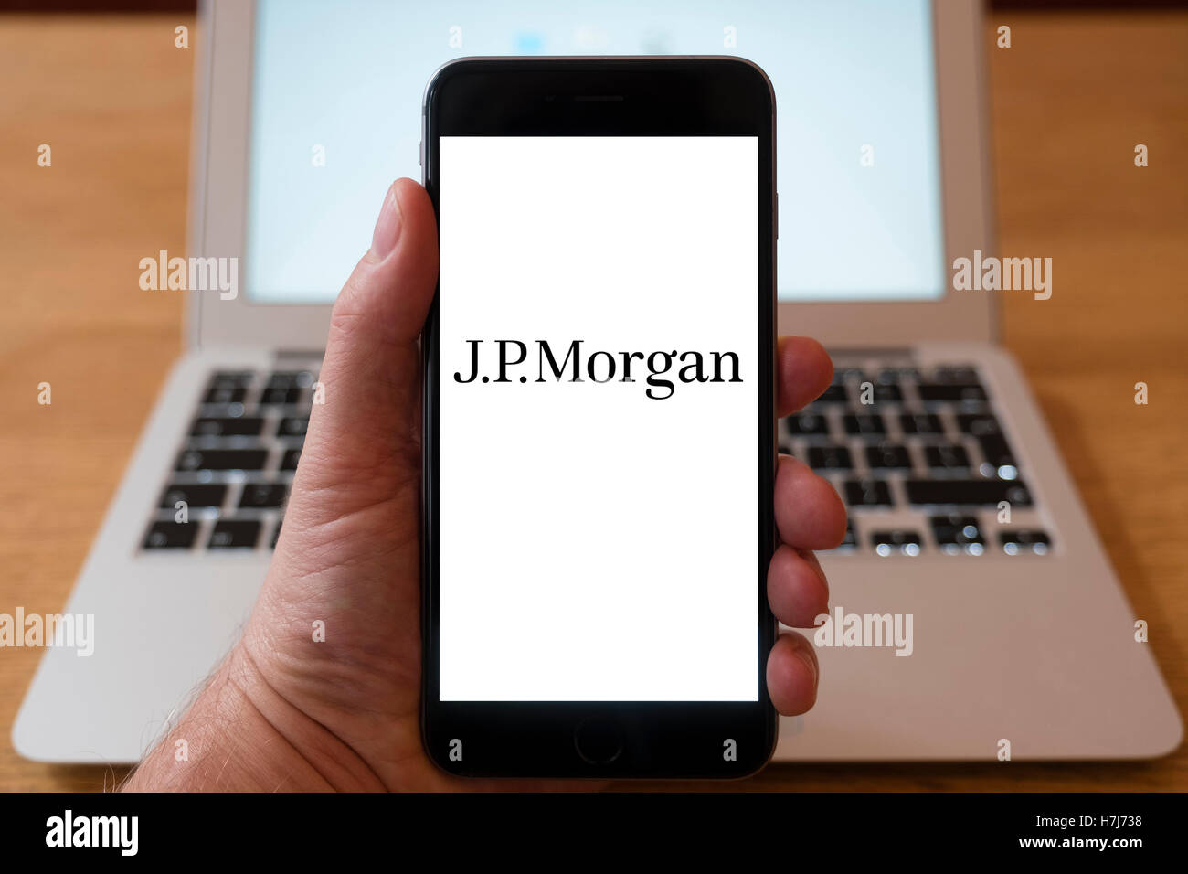 Using iPhone smartphone to display logo of JP Morgan bank Stock Photo