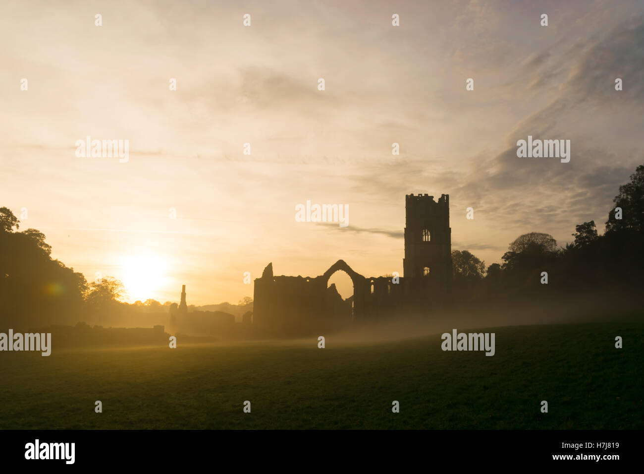 Fountains Abbey in the mist in autumn Stock Photo