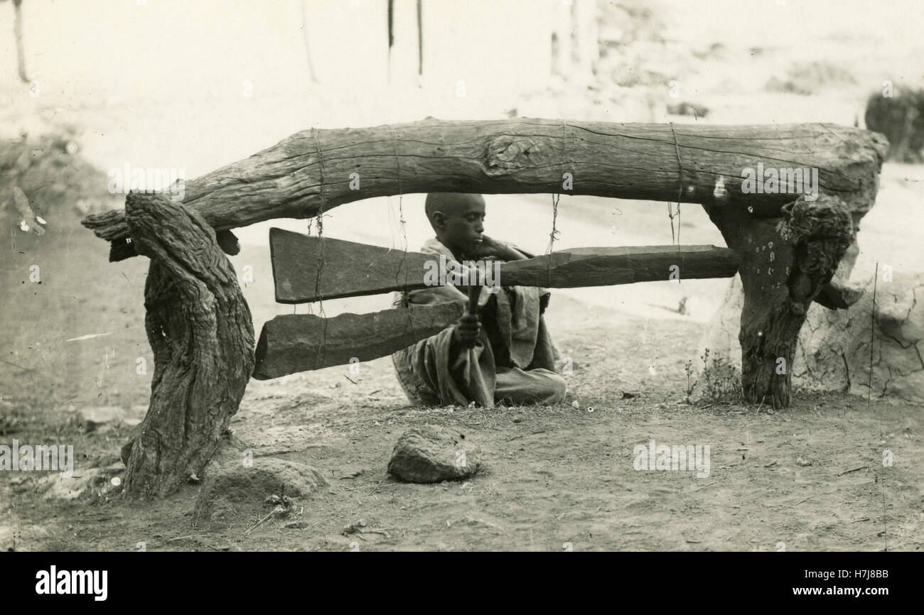 Boy playing stone bells, Africa Stock Photo