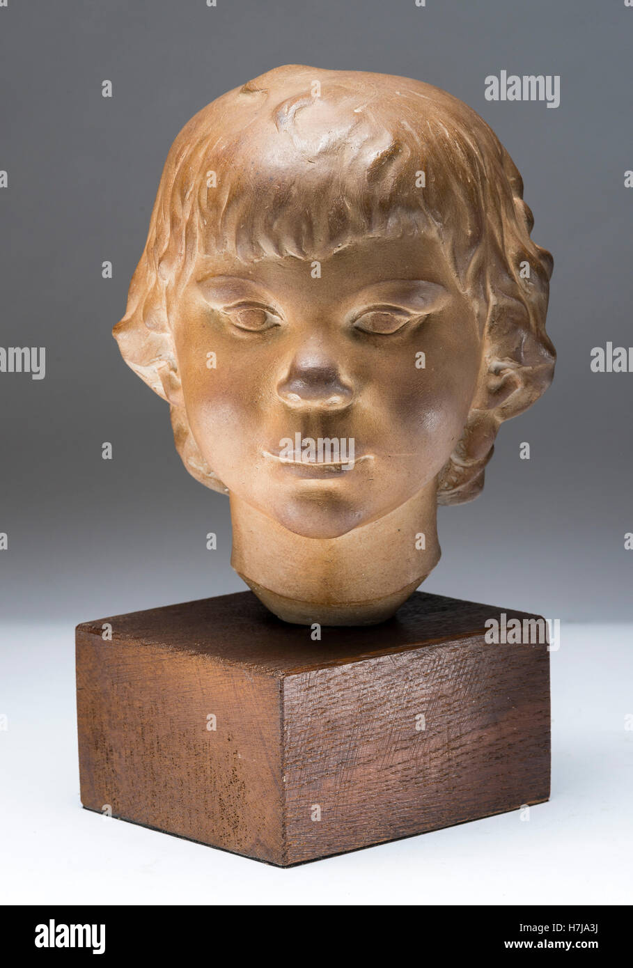 Child's bust, patinated plaster sculpture 1973 by French sculptor Jean Henninger Stock Photo