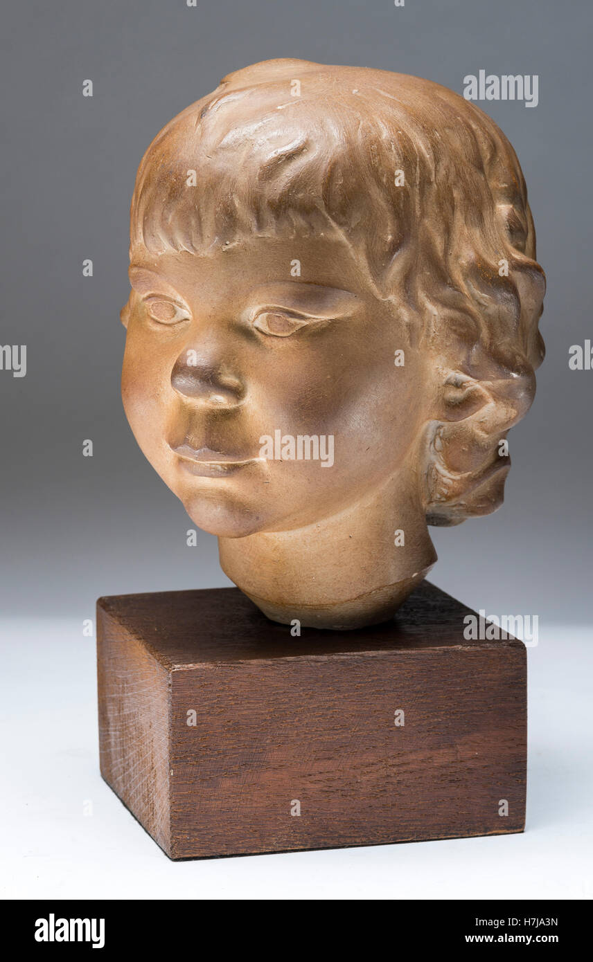 Child's bust, patinated plaster sculpture 1973 by French sculptor Jean Henninger Stock Photo
