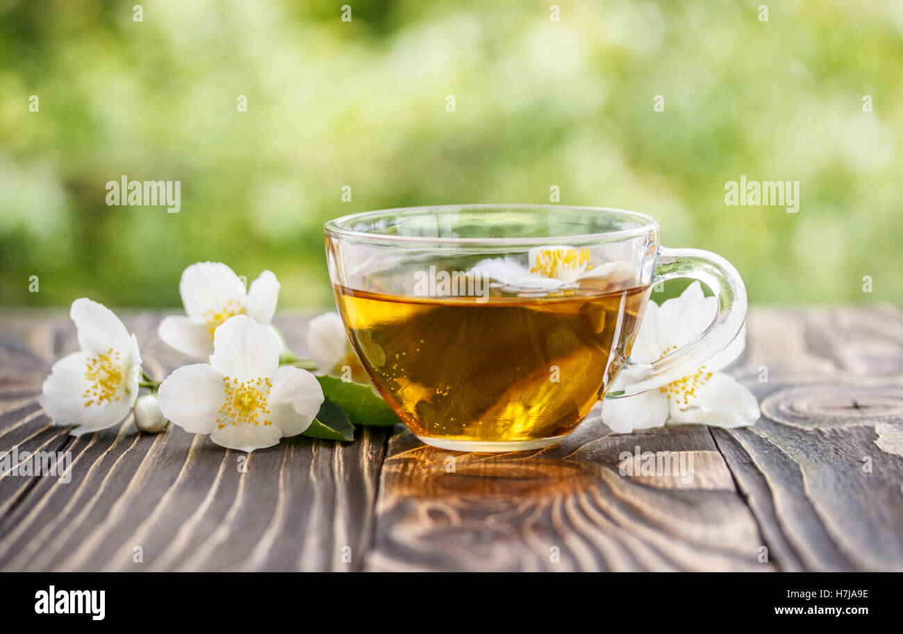 jasmine tea and jasmine flowers on  wooden background Stock Photo