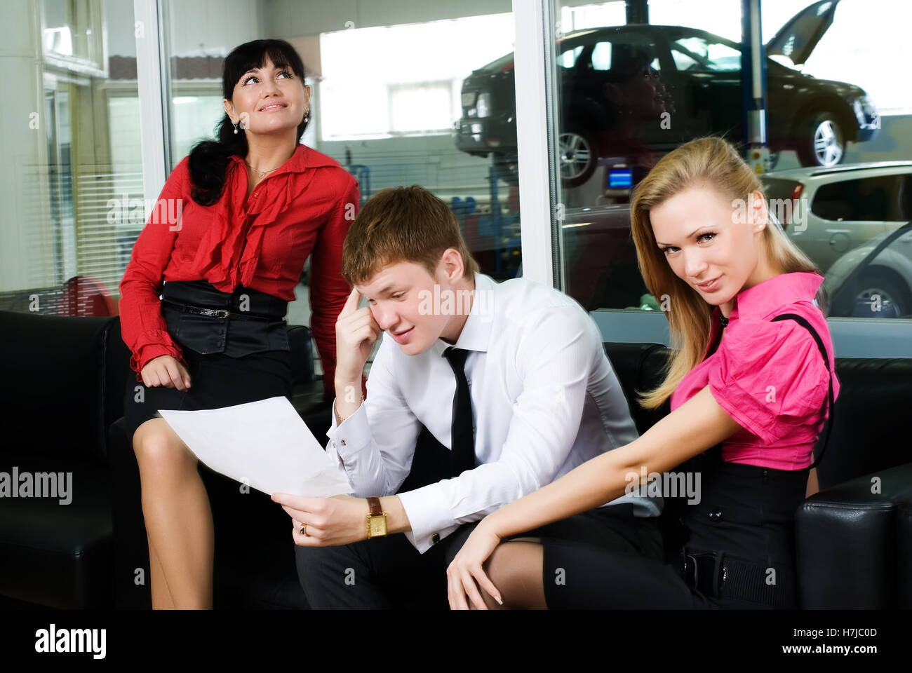 Attractive couple in car shop Stock Photo