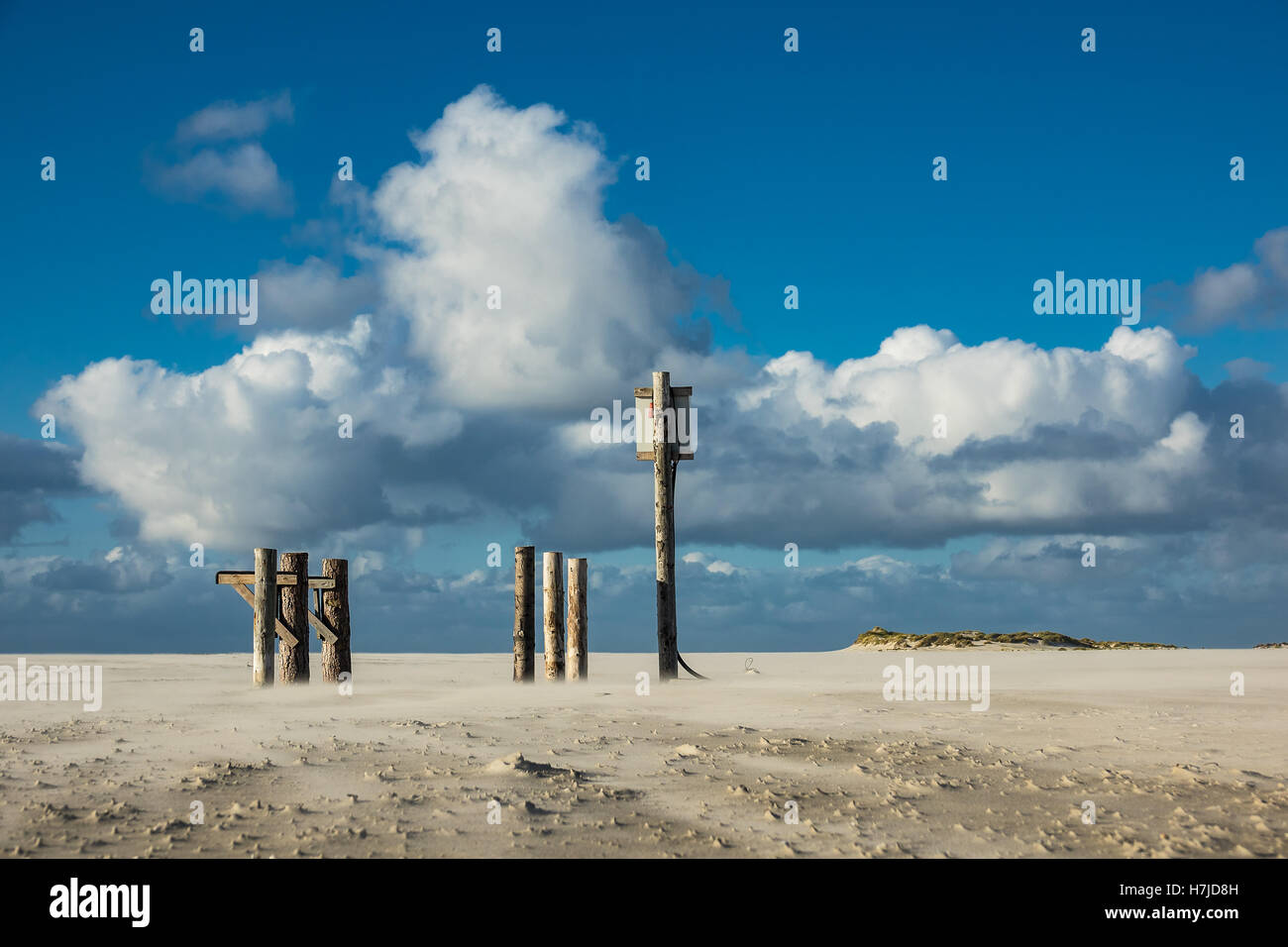 Poles on the North Sea coast on the island Amrum, Germany Stock Photo