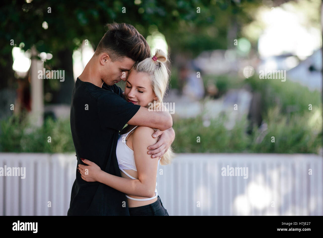 Happy young couple at a park Stock Photo - Alamy