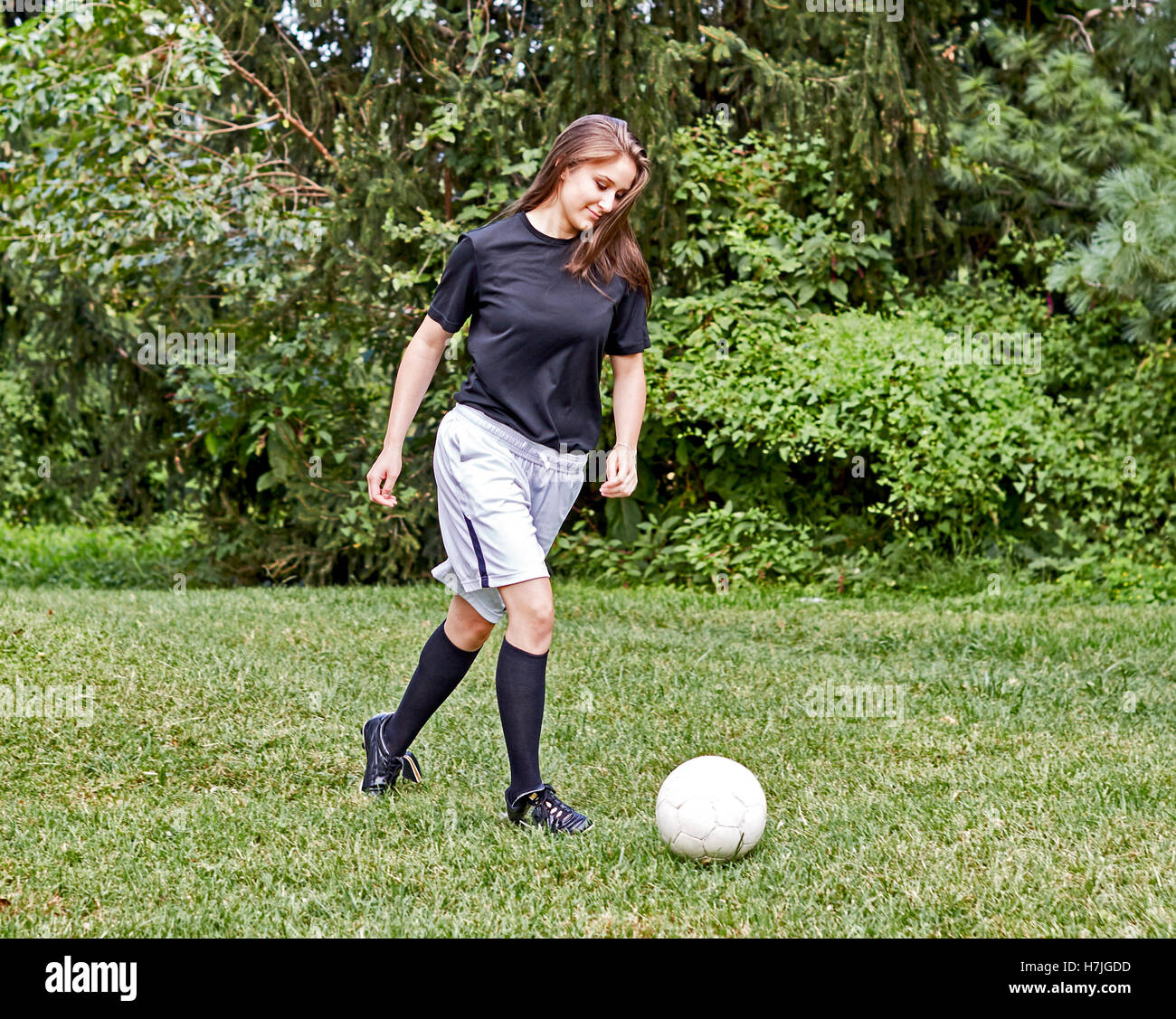 Girl kicking ball hires stock photography and images Alamy